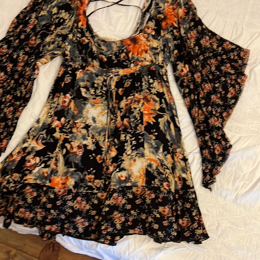 Beautiful flower dress very flowy , you can adjust waist.goes mid thigh.